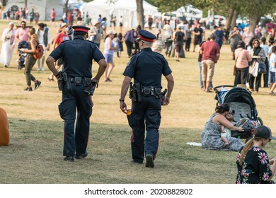 Edmonton, Canada,, July 31, 2021:Two Police Officer  Are Walking Through Park That Hold  A Festival