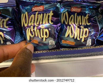 Edmonton, Canada - July 5, 2021: A Black Person Reaching For A Package Of Nestle's Walnut Whip On A Grocery Store Shelf