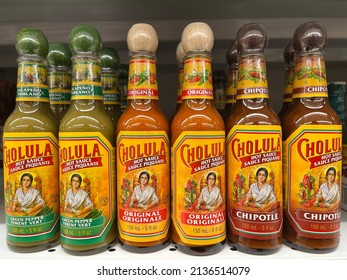 Edmonton, Canada - March 5, 2022: Bottles Of Green Pepper, Original, And Chipotle Cholula Hot Sauce On Display In A Grocery Store