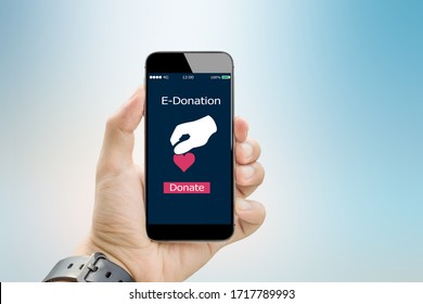 E-donation Concept.man Hands Make An Online Donate Via Mobile Phone On Blurred Abstract Background