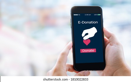 e-donation concept.close-up of man hands make an online donate via mobile phone - Shutterstock ID 1810022833