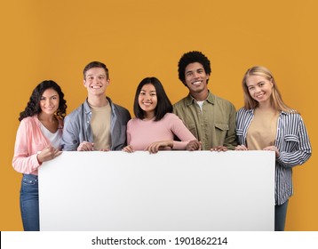 Education, Ad And Student Recommendations. Diverse Teens Cheerful International Students Holding Big Banner With Free Space And Ready To Study At College, Isolated On Beige Background, Studio Shot