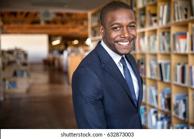 Education Administrator Faculty Member Standing In University Hall Library With Nice Smile