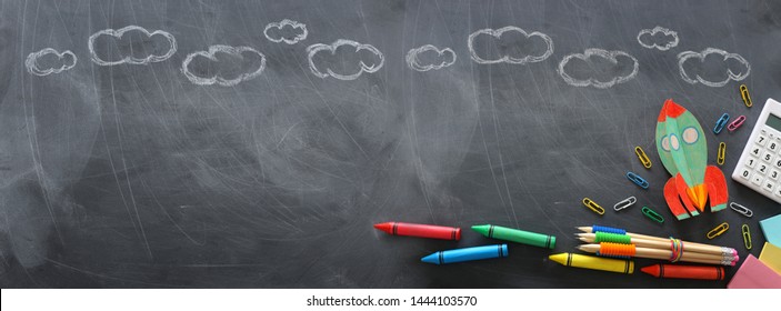 education. Back to school concept. rocket cut from paper and painted over blackboard background. top view, flat lay. banner - Powered by Shutterstock