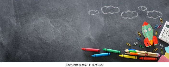 education. Back to school concept. rocket cut from paper and painted over blackboard background. top view, flat lay. banner - Shutterstock ID 1446761522
