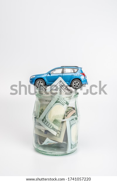 Education\
budget concept. Car money savings in a\
glass