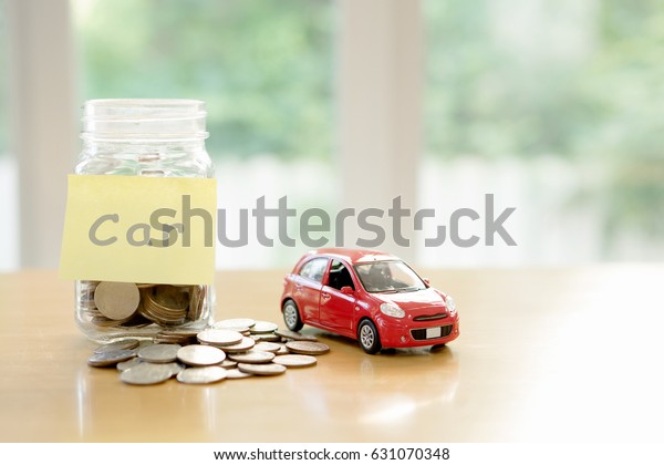 Education
budget concept. Car money savings in a
glass