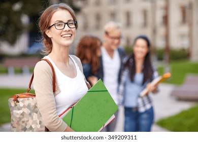 Education, Campus, Friendship And People Concept - Group Of Happy Teenage Students With School Folders