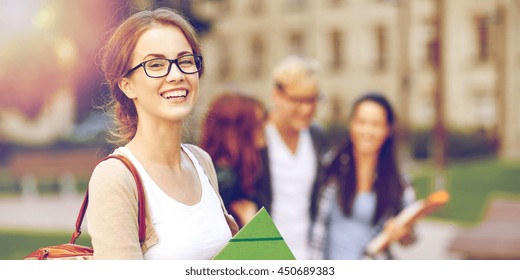 education, campus, friendship and people concept - group of happy teenage students with school folders - Shutterstock ID 450689383