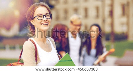 education, campus, friendship and people concept - group of happy teenage students with school folders