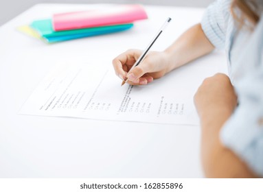 Education, Children And School Concept - Little Student Girl Taking Test