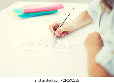 Education, Children And School Concept - Little Student Girl Taking Test