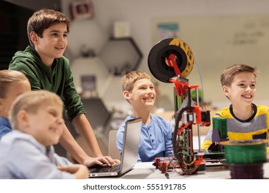 education, children, technology, science and people concept - group of happy kids with 3d printer and laptop computer at robotics school lesson