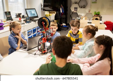 Education, Children, Technology, Science And People Concept - Group Of Happy Kids With 3d Printer And Laptop Computer At Robotics School Lesson