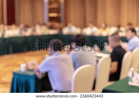 Education concept, Abstract blurred background image of students and business people studying and discuss in large hall profession seminar with screen