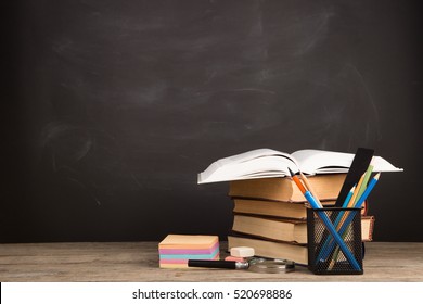 Education concept - books on the desk in the auditorium - Shutterstock ID 520698886