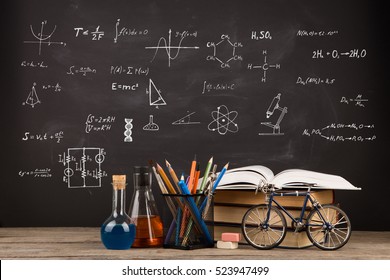Education concept - books on the desk in the auditorium