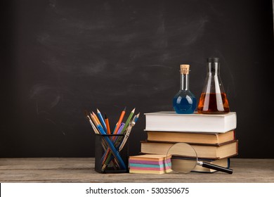 Education concept - books on the desk in the auditorium