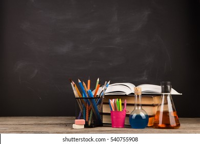 Education concept - books on the desk in the auditorium