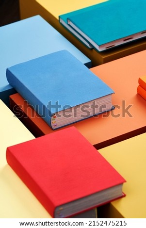 Education concept with books stacked on pastel color background . Blank book cover with copy space for text. Colorful books hardcover 