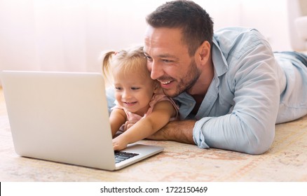 Education Concept. Happy Father Teaching His Little Toddler Girl How To Use Personal Computer, Copy Space