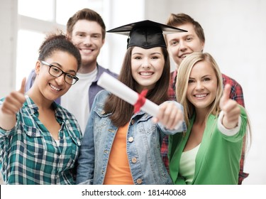 education concept - happy girl in graduation cap with diploma and students - Powered by Shutterstock