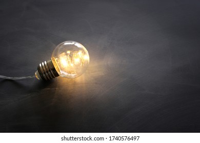 Education concept image. Creative idea and innovation. Light bulb as metaphor over blackboard