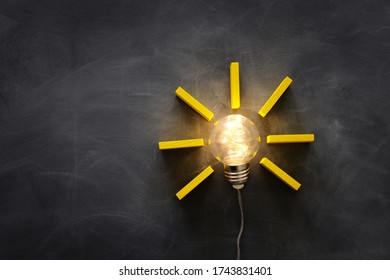 Education concept image. Creative idea and innovation. Light bulb as metaphor over blackboard