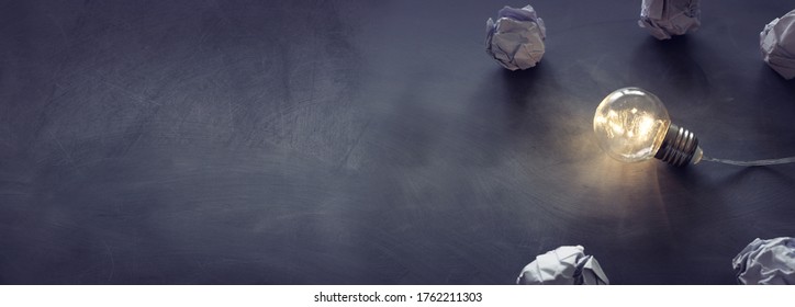 Education concept image. Creative idea and innovation. Light bulb as metaphor over blackboard