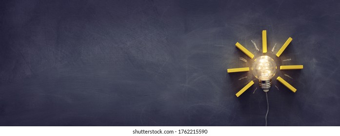Education concept image. Creative idea and innovation. Light bulb as metaphor over blackboard - Shutterstock ID 1762215590