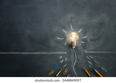 Education concept image. Creative idea and innovation. light bulb metaphor over blackboard background