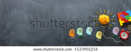 Education concept image. Creative idea and innovation. Crumpled paper as light bulb metaphor over blackboard
