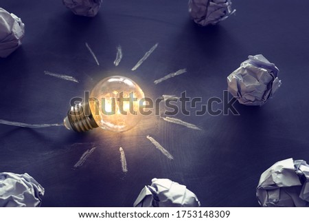 Education concept image. Creative idea and innovation. Light bulb as metaphor over blackboard
