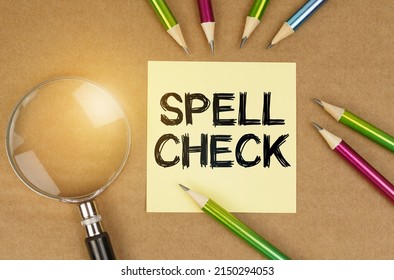Education concept. On the table are pencils, a magnifying glass and a sticker with the inscription - Spell Check - Shutterstock ID 2150294053