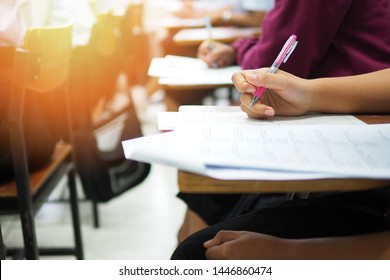 Education concept picture of students taking test. High school girl students working on study assignments in the classroom of vocational or professional training program. Learners doing an examination