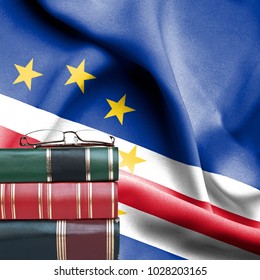 Education concept - Stack of books and reading glasses against National flag of Cape Verde - Shutterstock ID 1028203165
