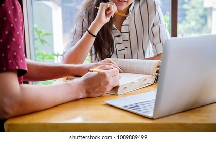 Education concept. Students studying and brainstorming campus concept. Close up of students discussing their subject on books textbooks and writing to notebook. Selective focus. - Shutterstock ID 1089889499