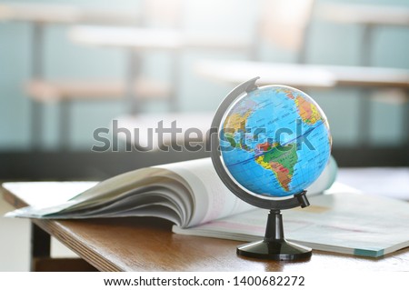 Education concept,Modeled globe with geography books on the table.Study of maps and using geographic tools.Innovative teaching materials for objects.Learning management in the 21st century.