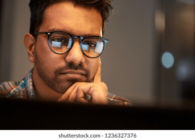 Education, Deadline And People Concept - Close Up Of Creative Man In Glasses Working At Night Office And Thinking