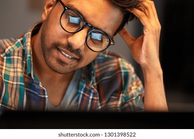 Education, Deadline And People Concept - Close Up Of Creative Man In Glasses Working At Night Office And Thinking