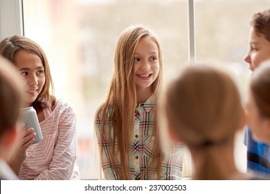 Education, Elementary School, Drinks, Children And People Concept - Group Of School Kids With Soda Cans Talking In Corridor