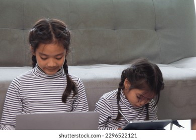Education, elementary school, learning, technology and people concept - group of school kids with tablet pc computer having fun 