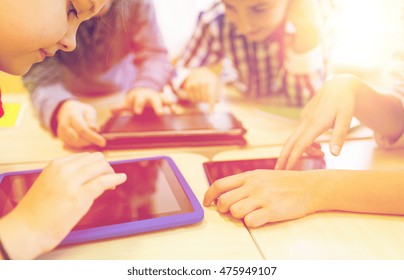 Education, Elementary School, Learning, Technology And People Concept - Close Up Of School Kids With Tablet Pc Computers Having Fun And Playing On Break In Classroom