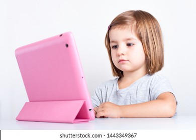 Education, Elementary School, Technology, Advertisement And Children Concept - Little  Girl Using Tablet/ipad/pc On A White Background Girl Ready To Study. Mockup, Place For Text. 