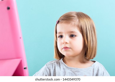 Education, Elementary School, Technology, Advertisement And Children Concept - Little  Girl Using Tablet/ipad/pc On A White Background Girl Ready To Study. Mockup, Place For Text. 