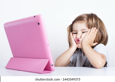 education, elementary school, technology, advertisement and children concept - little  girl using tablet/ipad/pc on a white background Girl ready to study. Mockup, place for text. 