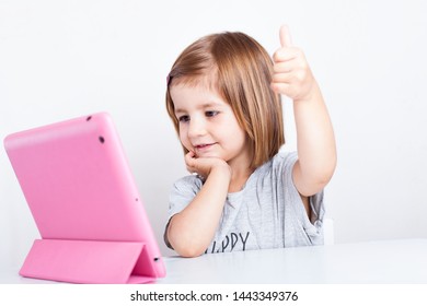 Education, Elementary School, Technology, Advertisement And Children Concept - Little  Girl Using Tablet/ipad/pc On A White Background Girl Ready To Study. Mockup, Place For Text. 