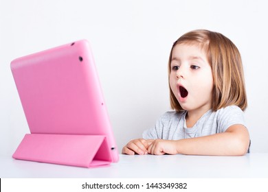 Education, Elementary School, Technology, Advertisement And Children Concept - Little  Girl Using Tablet/ipad/pc On A White Background Girl Ready To Study. Mockup, Place For Text. 