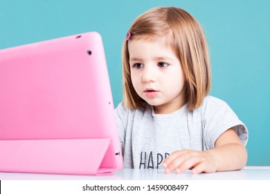 Education, Elementary School, Technology, Advertisement And Children Concept -  Funny Schoolchild Girl With Tablet,iPad,pc And Notebook, Diary On A White Background. Girl Ready To Study. Copy Space