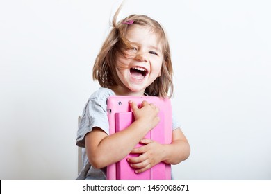 Education, Elementary School, Technology, Advertisement And Children Concept -  Funny Schoolchild Girl With Tablet,iPad,pc And Notebook, Diary On A White Background. Girl Ready To Study. Copy Space